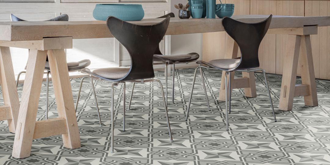 Tile patterned vinyl flooring in a kitchen under a wooden dining table